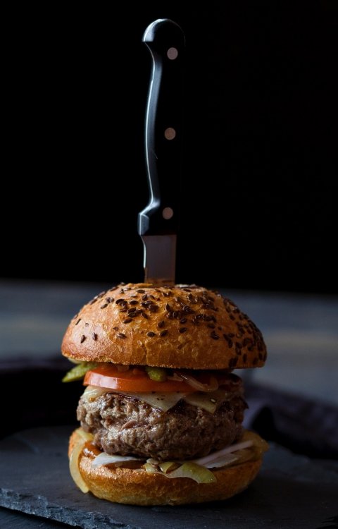 hamburger with knife sticking in the top